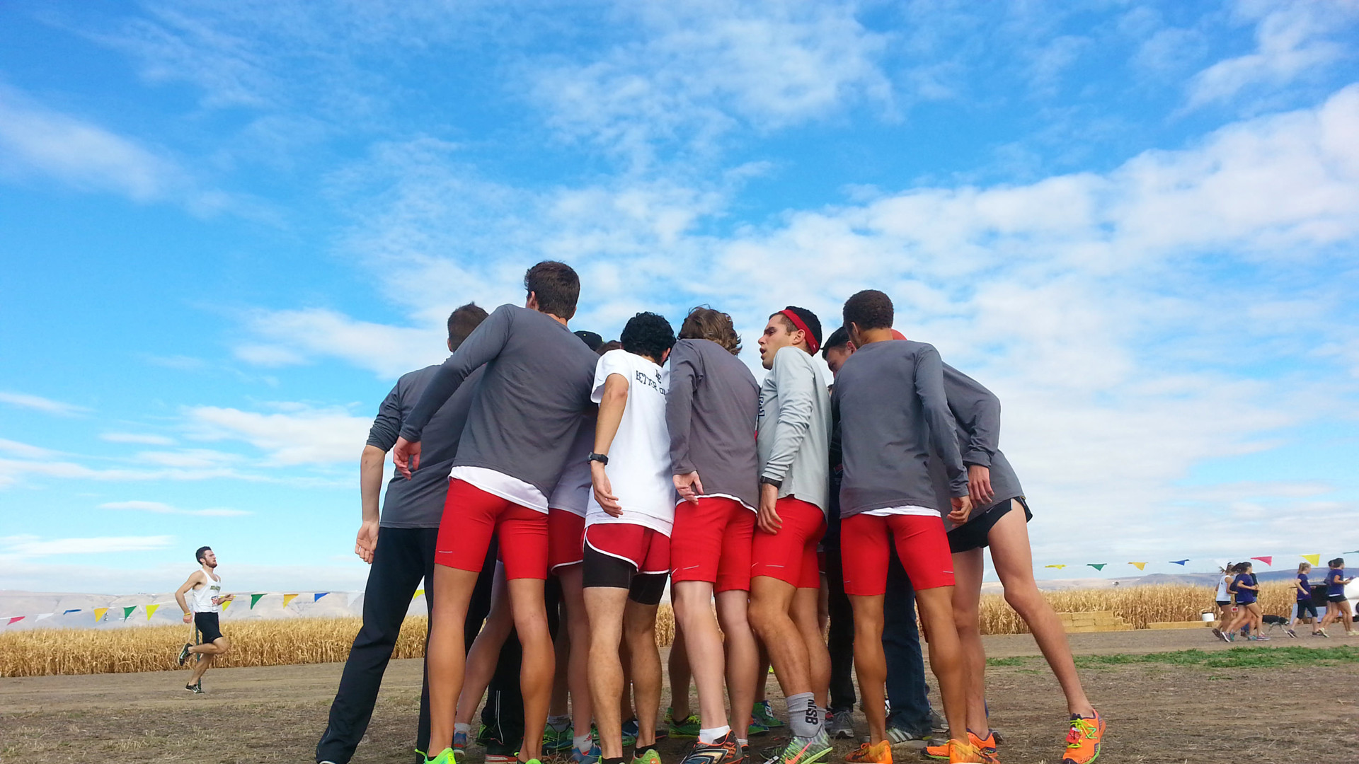 Cross country team in a huddle